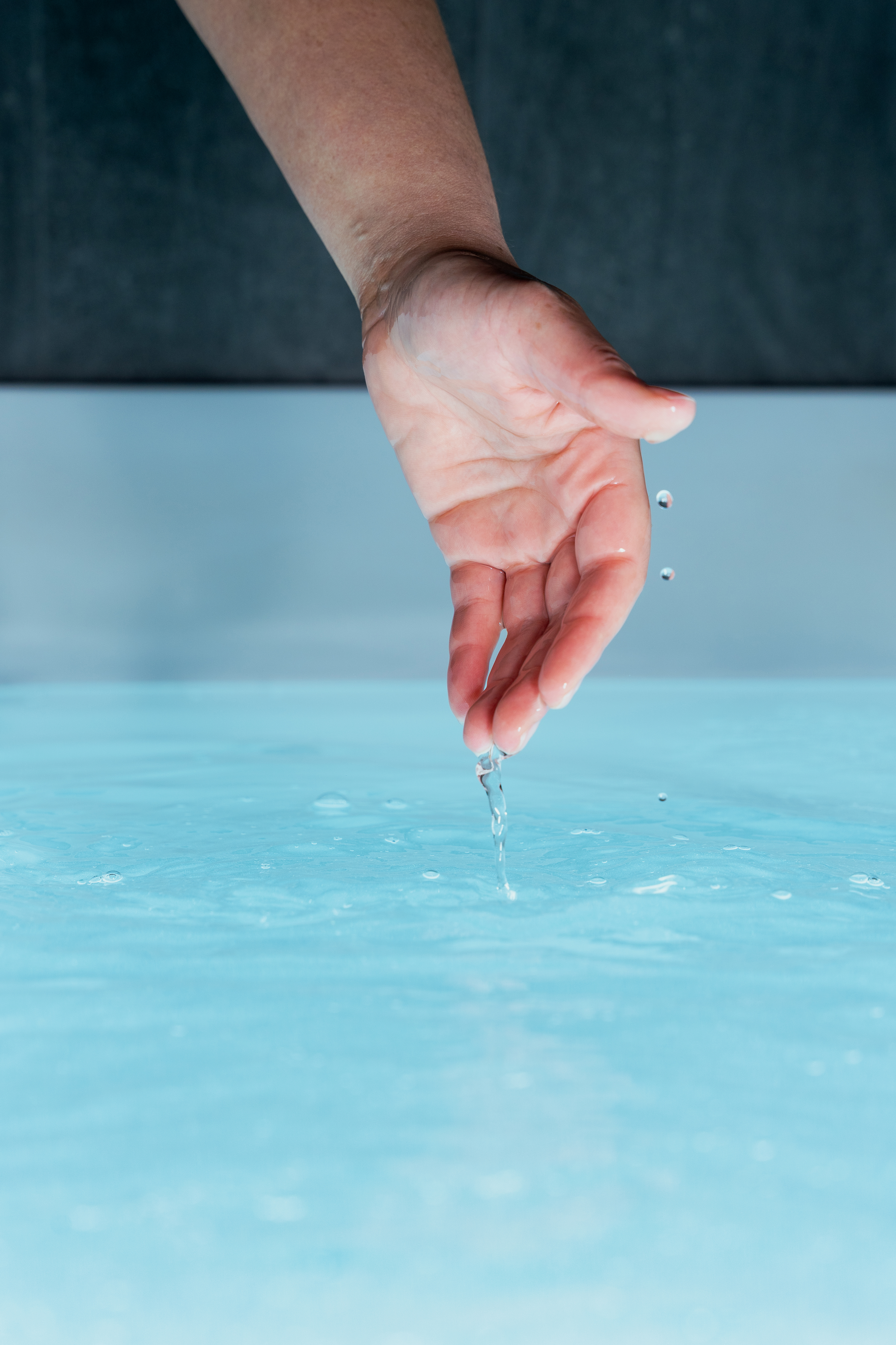 Revibe cold plunge therapy with hand entering icy water for recovery