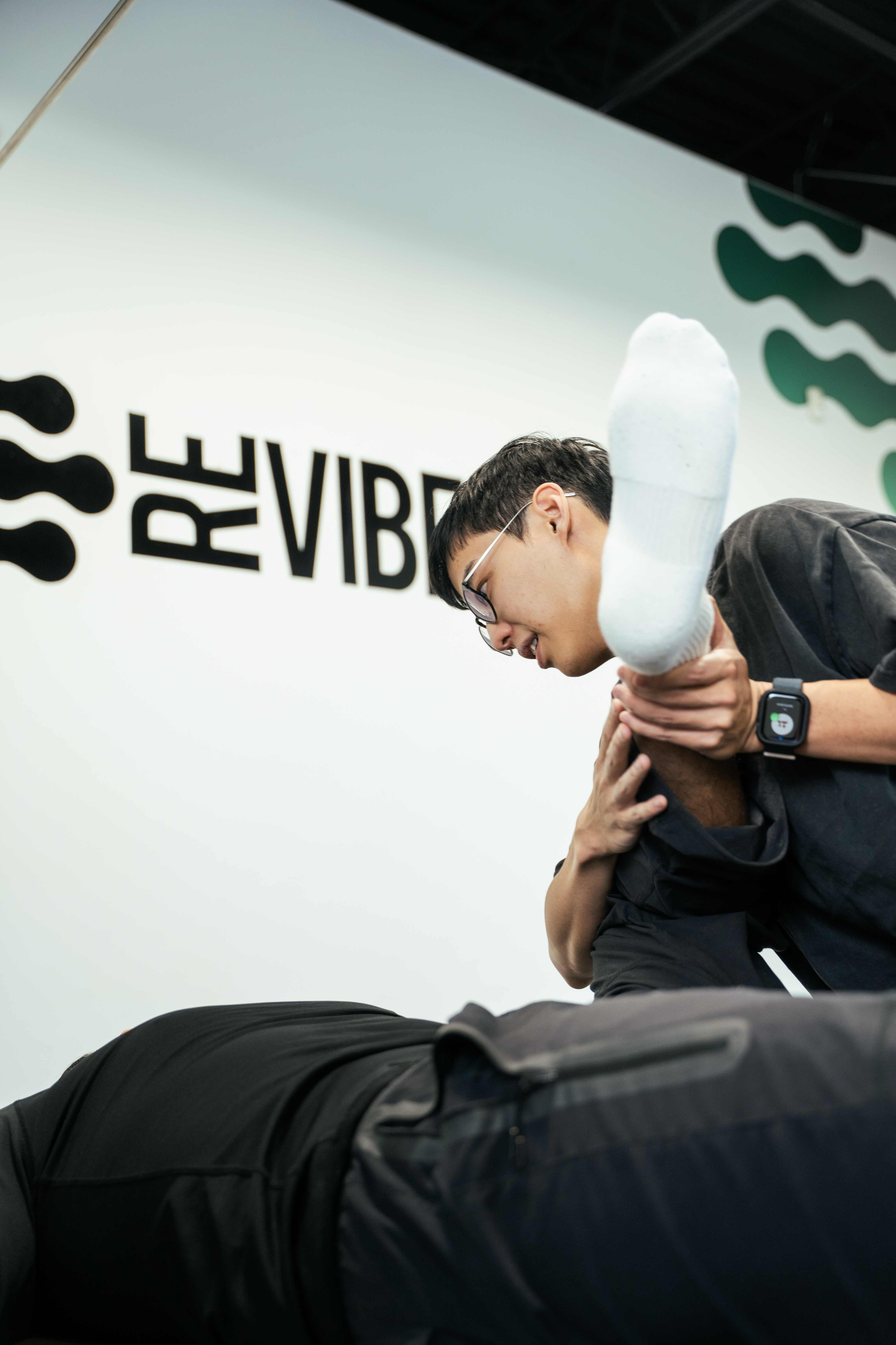 Physiotherapist performing a manual leg stretch on a patient